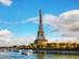 A view of the Eiffel Tower and River Seine in Paris on a cloudy blue day