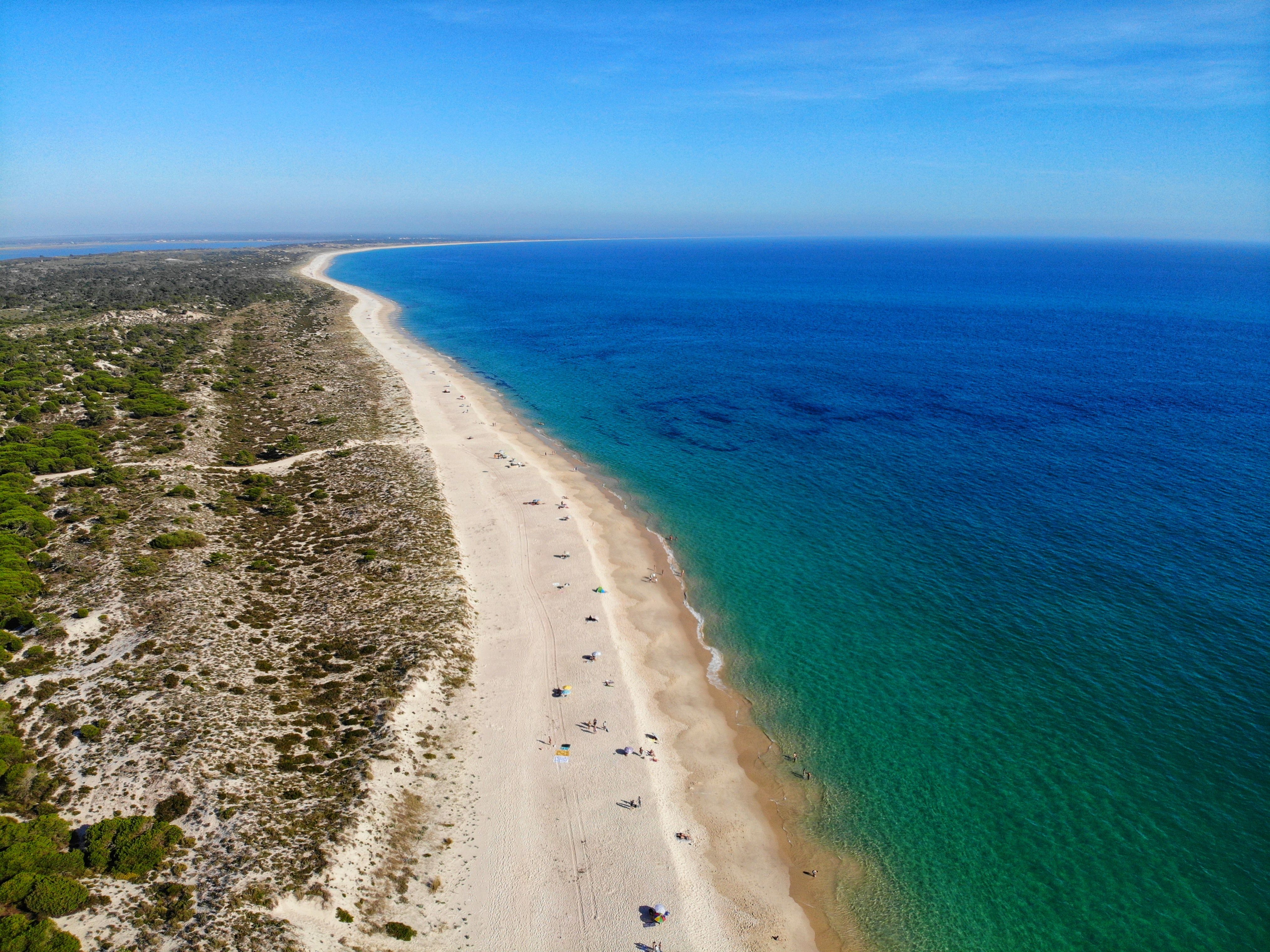 An aerial view of a stretch of Comporta beach (Praia da Comporta) on Portugal's Silver Coast