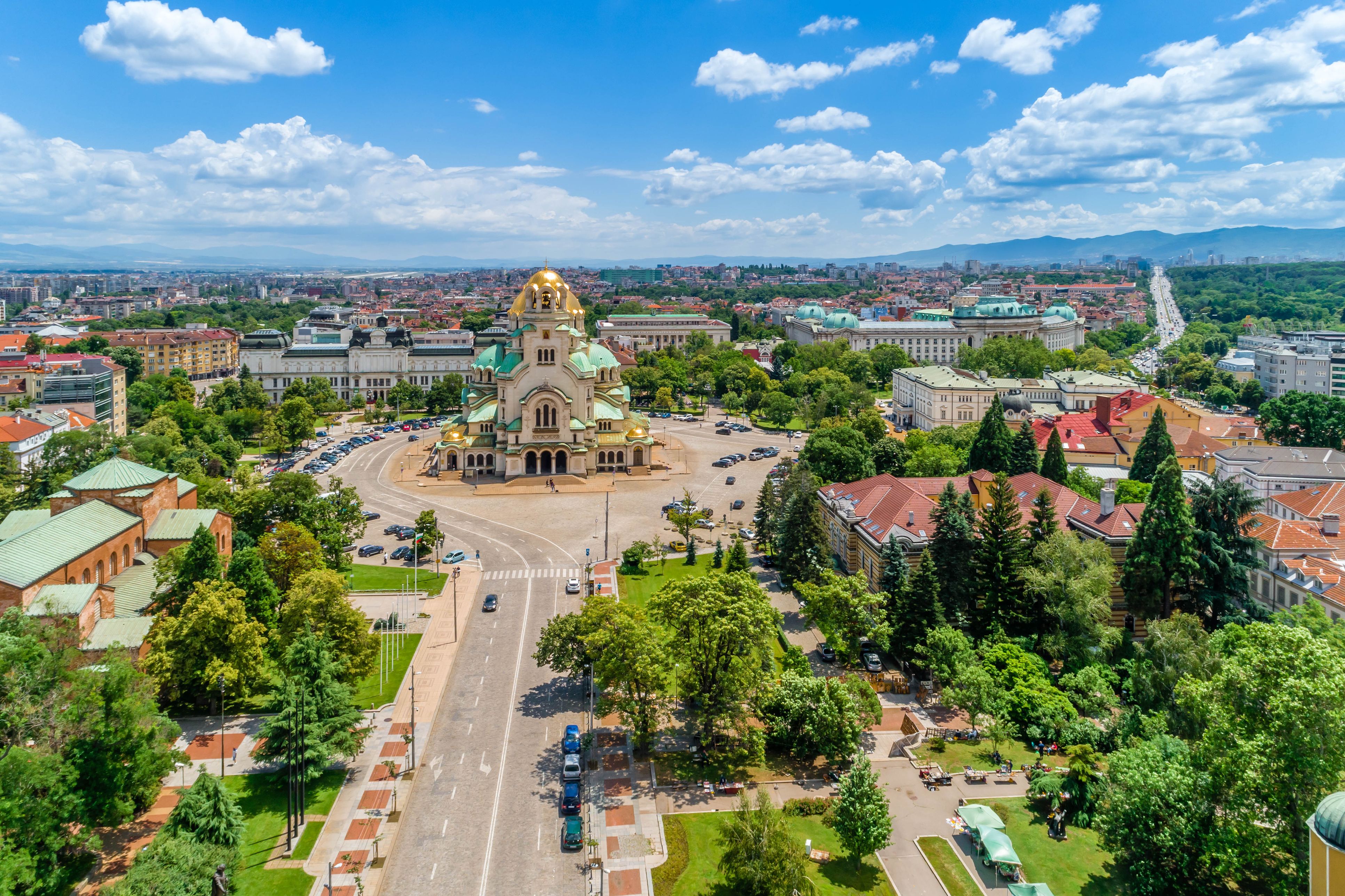 Aerial view of gold-domed Alexander Nevsky Cathedral and surrounding tree-filled plaza in Sofia