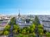 An aerial view of Paris with the Eiffel Tower on a bright, clear day