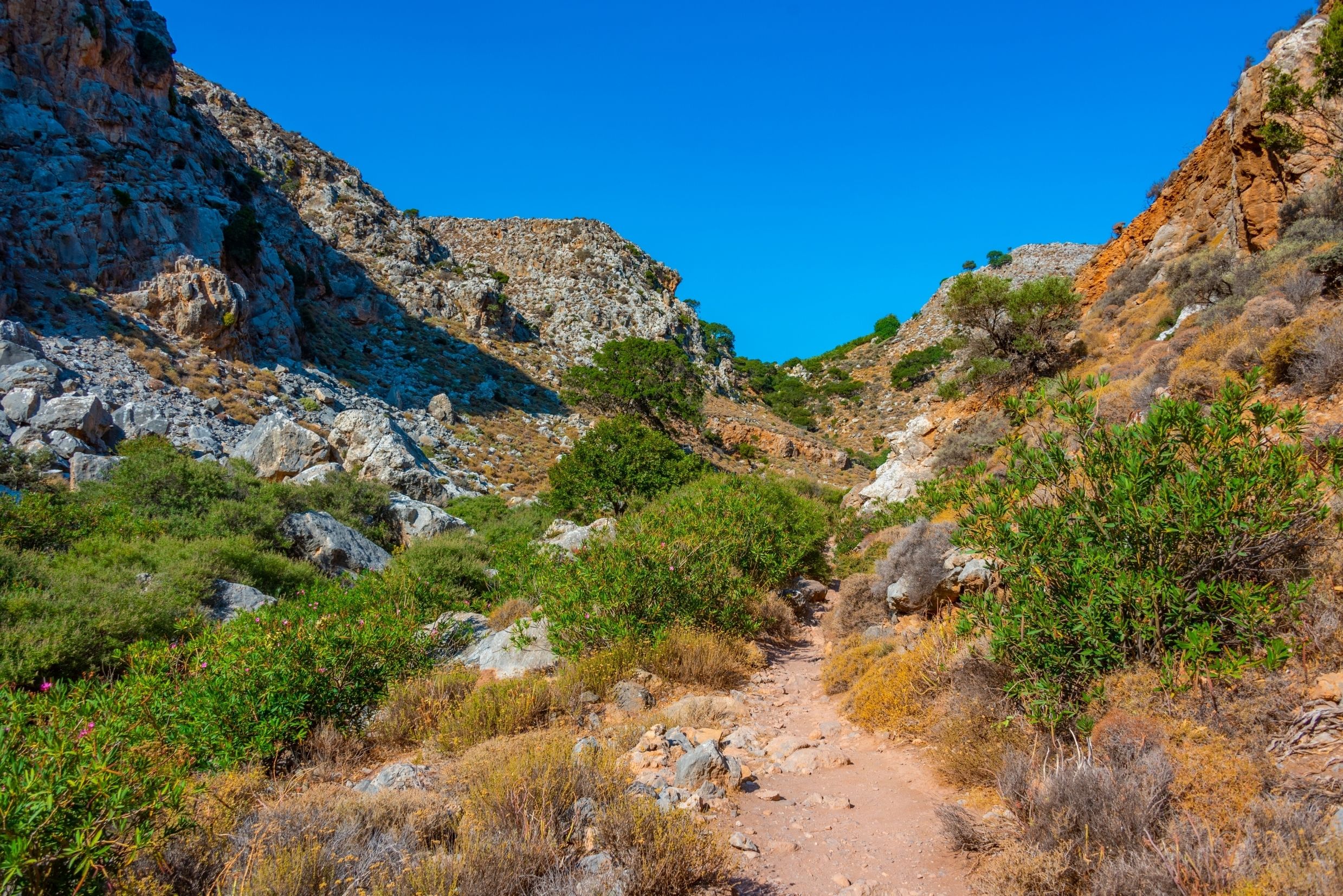 View of a dry rocky path leading through a gorge in Crete, Greece.