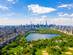 Aerial view of Central Park in New York with golf fields and tall skyscrapers surrounding the park