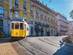 Famous vintage yellow tram 28 in the narrow streets of Alfama district in Lisbon, Portugal