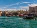 A view of Dubai Creek in the Al Fahidi district with colourful ferry boats on a bright blue day