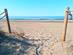 Entrance to an empty sandy beach in Spain