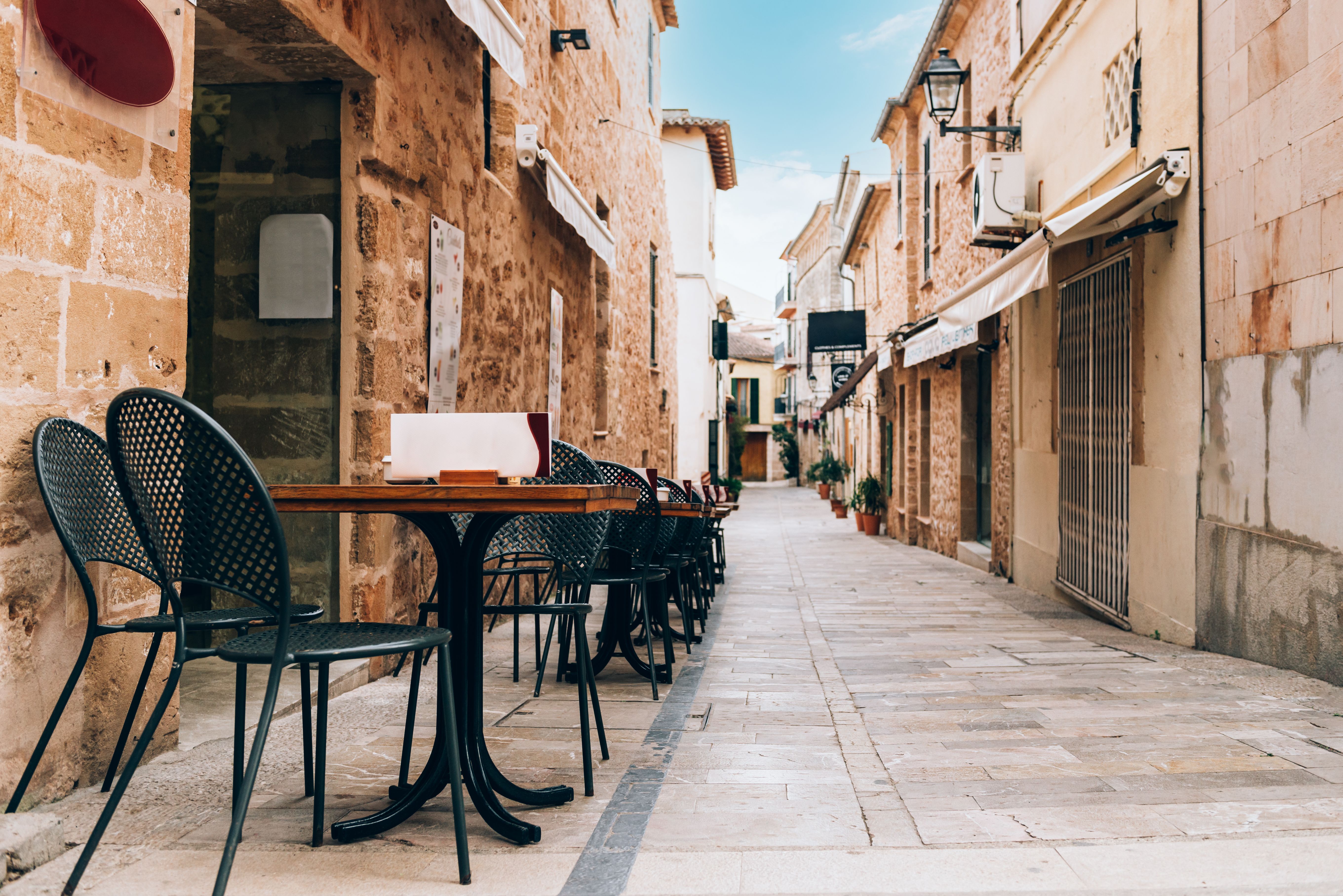 A view of cafe tables and chairs in a side street of Palma, Majorca