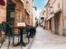 A view of cafe tables and chairs in a side street of Palma, Majorca