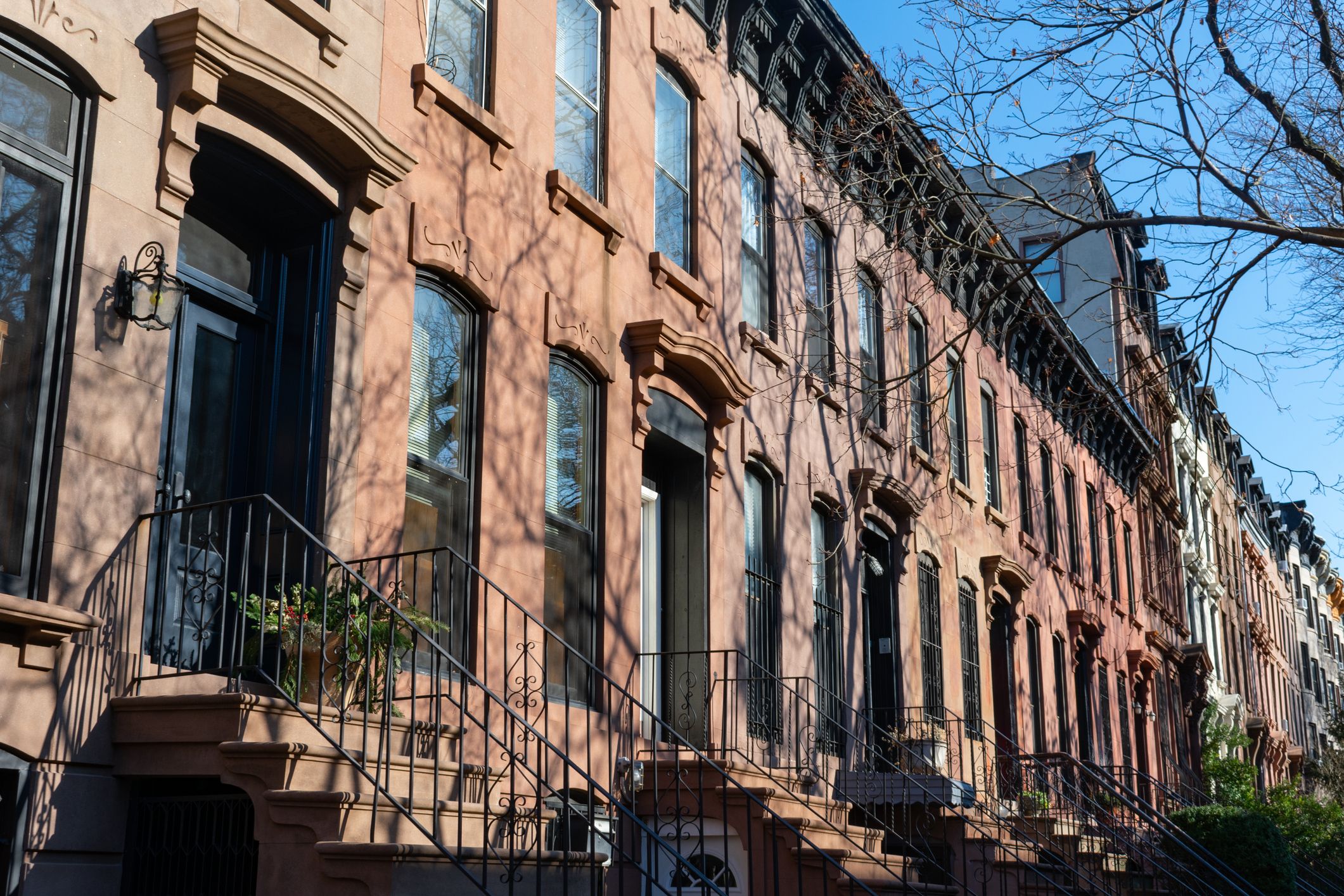 A row of old brownstone homes with staircases in Prospect Heights, Brooklyn, New York