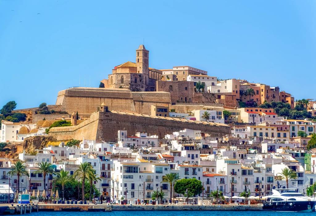 A sea side view to the Ibiza Old Town with Cathedral of Santa Maria d'Eivissa at the top of the hill in Ibiza, Spain.