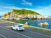 White car driving along a coastal road in Spain