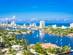 A view of Fort Lauderdale in Florida, showing the skyline over Barrier Island and boats anchored in the blue water