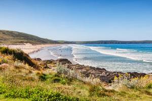 View across the cliffs overlooking the large sandy beach at Woolacombe in Devon on a sunny day