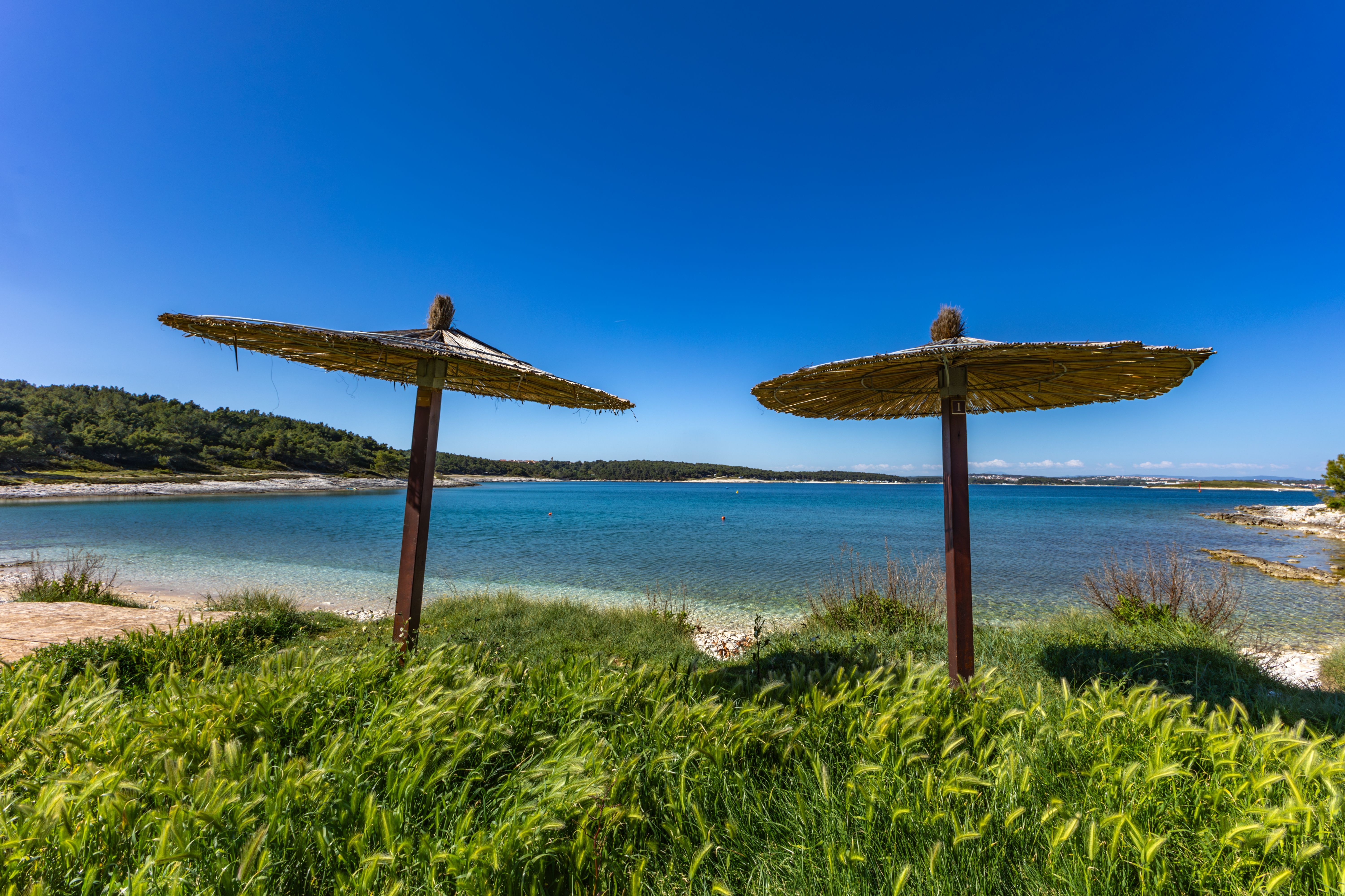 View of straw umbrellas on Debeljak Beach in Croatia