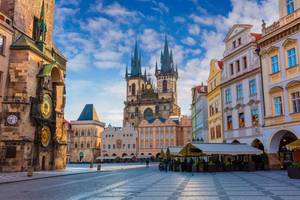 View of Prague's colourful Old Town square with the famous Tyn Church and its spires and the Astronomical Clock