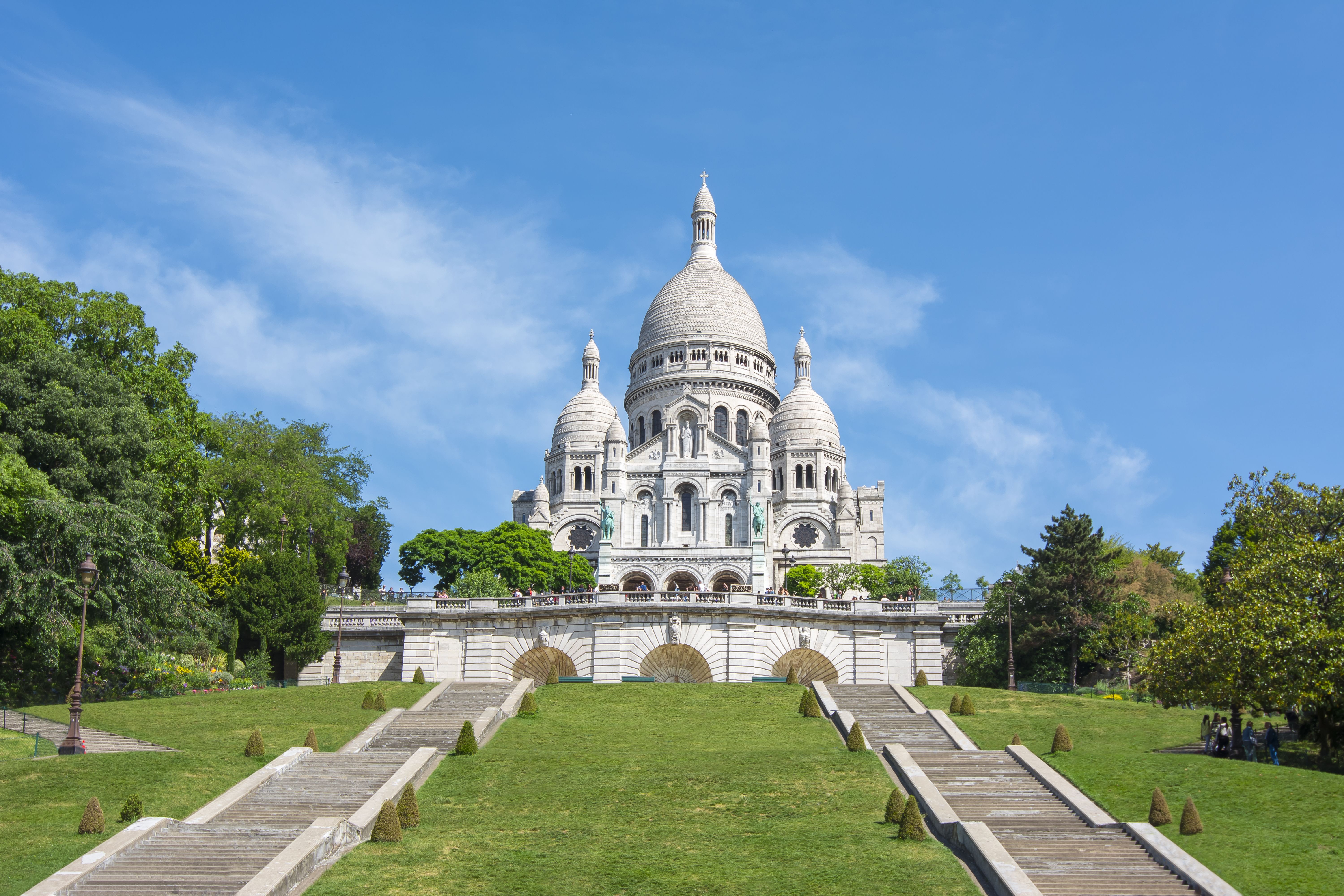 A view of the Sacre Coeur on Montmartre hill in Paris on a bright blue day
