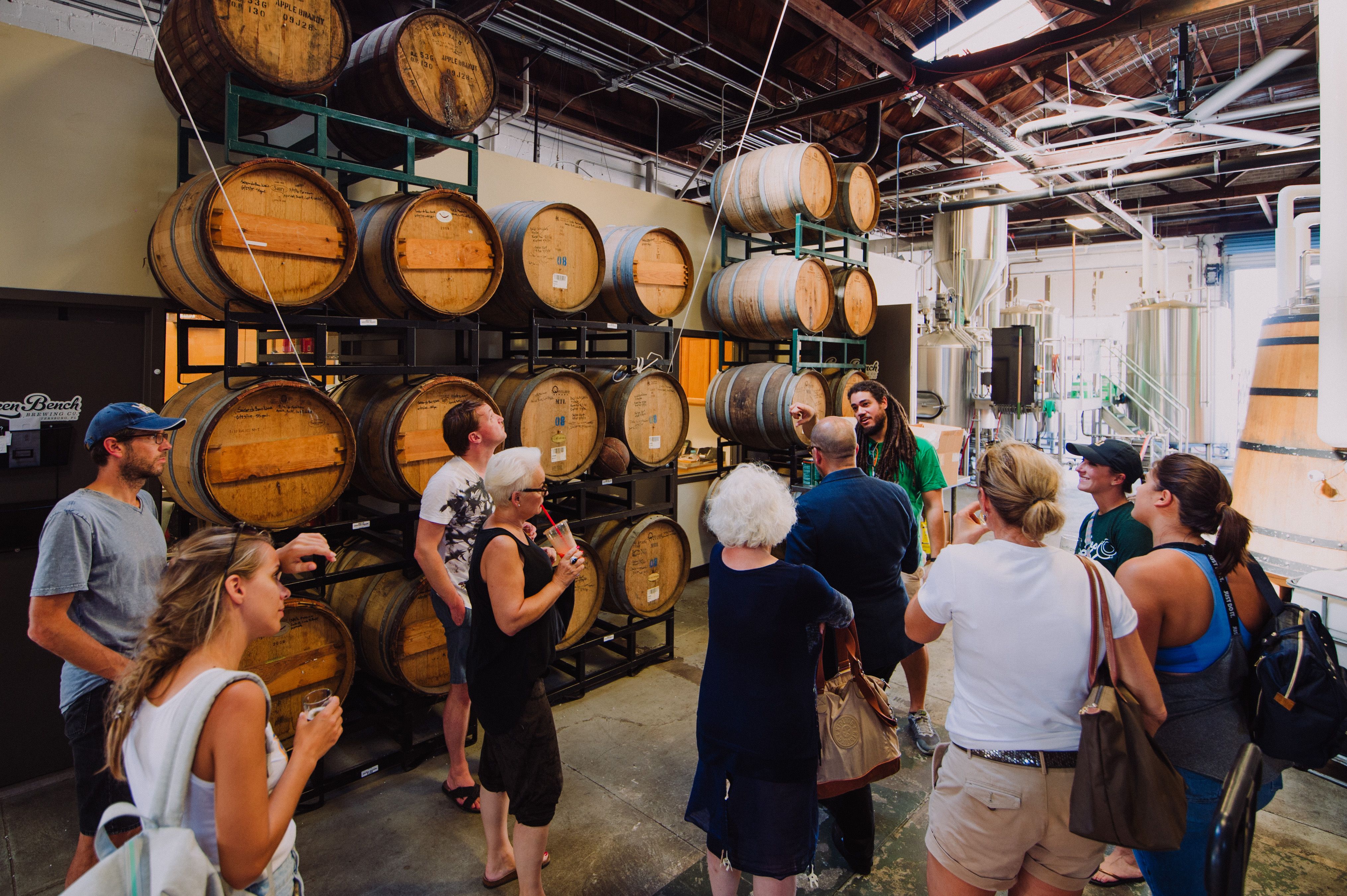A group of people in a tour at a craft brewery in St. Pete-Clearwater, Florida