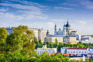 The spanish skyline showing The Cathedral of Saint Mary the Royal of the Almudena, the Almudena Cathedral, and the Royal Palace in Madrid, Spain