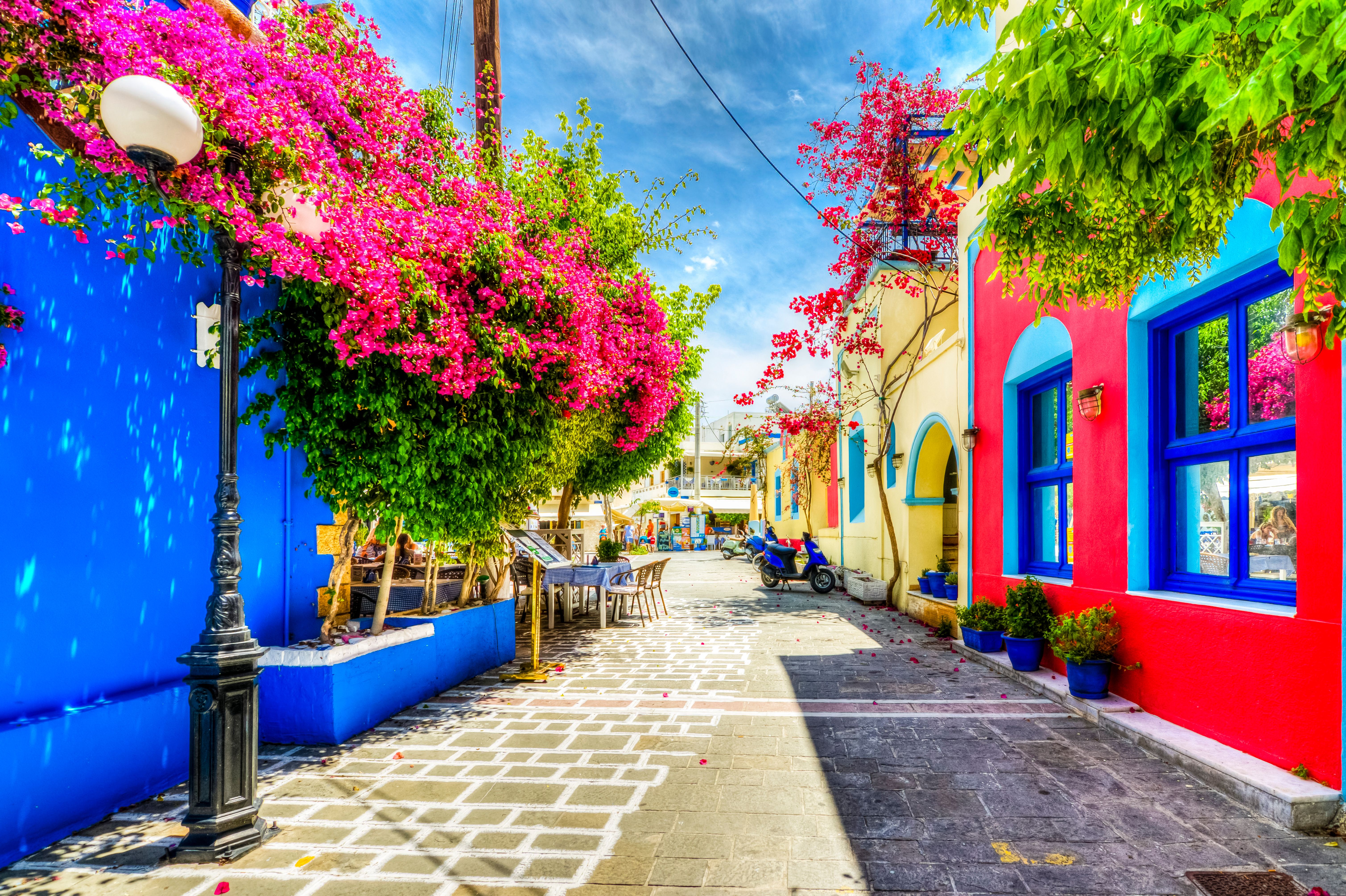 Beautiful street view in Kos town with colourful houses and flowers