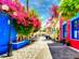 Beautiful street view in Kos town with colourful houses and flowers