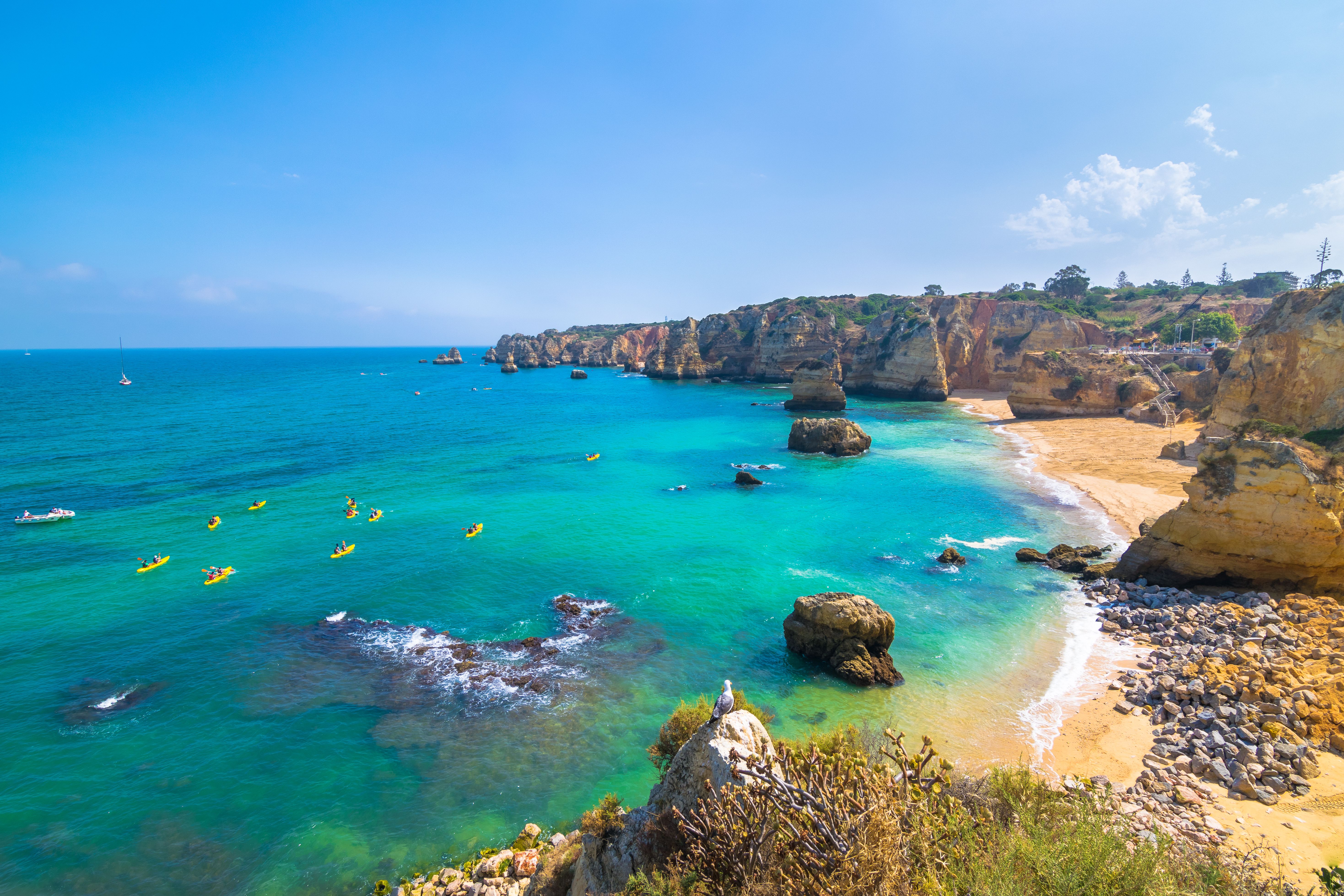 A view of Lagos coastline with the Ponta da Piedade cliffs and sea kayakers in the Algarve