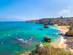 A view of Lagos coastline with the Ponta da Piedade cliffs and sea kayakers in the Algarve