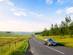 Motion blur on a single car as it speeds along a winding countryside road in the Scottish Borders