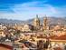 Early morning view of the Palermo skyline with its pastel yellow houses and the dome and bell tower of its cathedral
