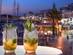 A view of two cocktails by a marina with a blurred background