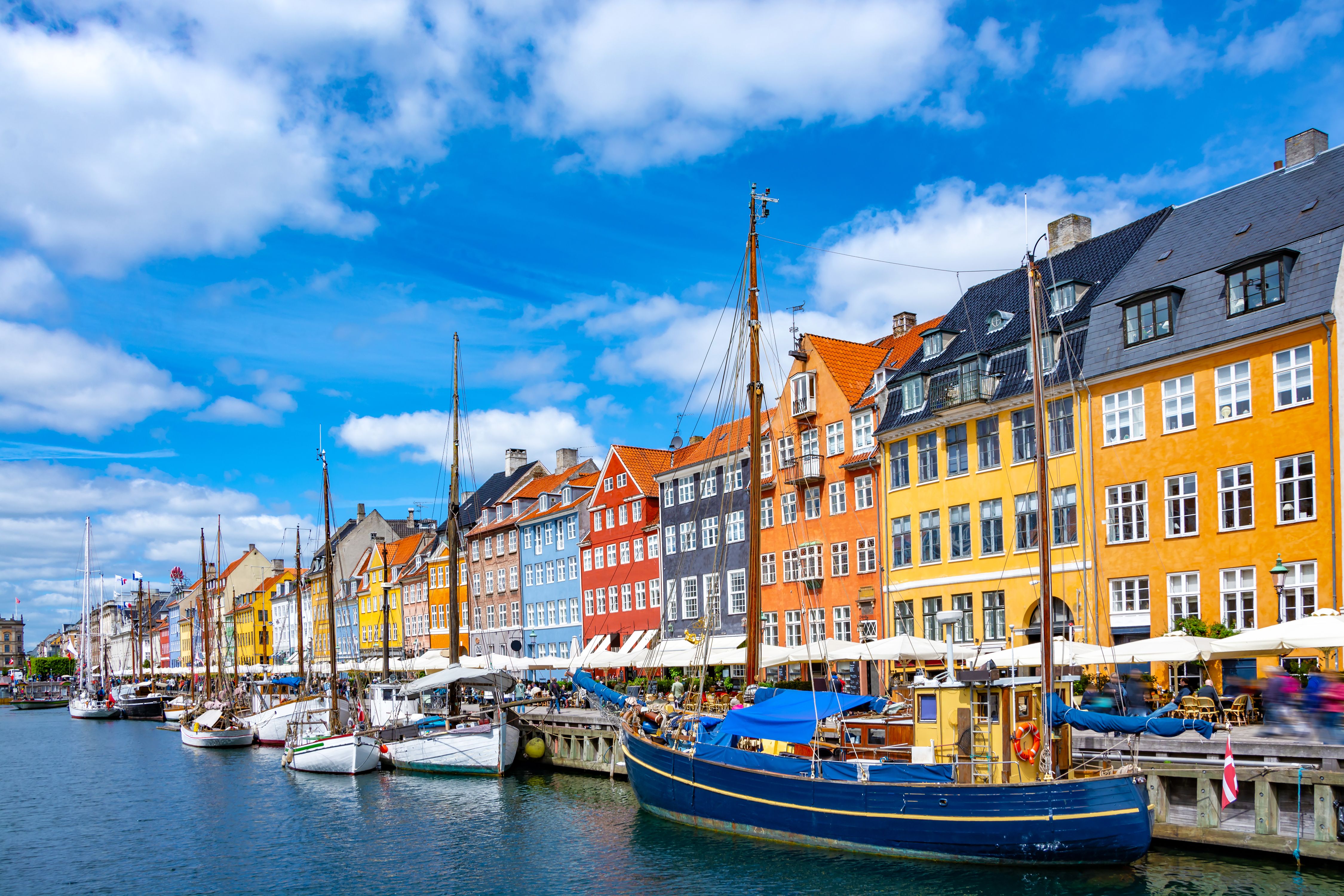 View of Nyhavn canal waterfront with colourful houses and sail boats in Copenhagen