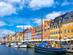 View of Nyhavn canal waterfront with colourful houses and sail boats in Copenhagen