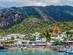 View of white-washed houses and colourful boats on the island of Panarea in Sicily