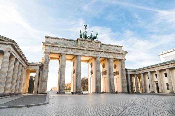 Sunrise illuminated the colonnaded Brandenburger Tor gate with an empty square in front