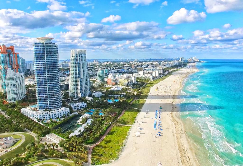Wide angle shot of water, beach and city of Miami Beach, Florida
