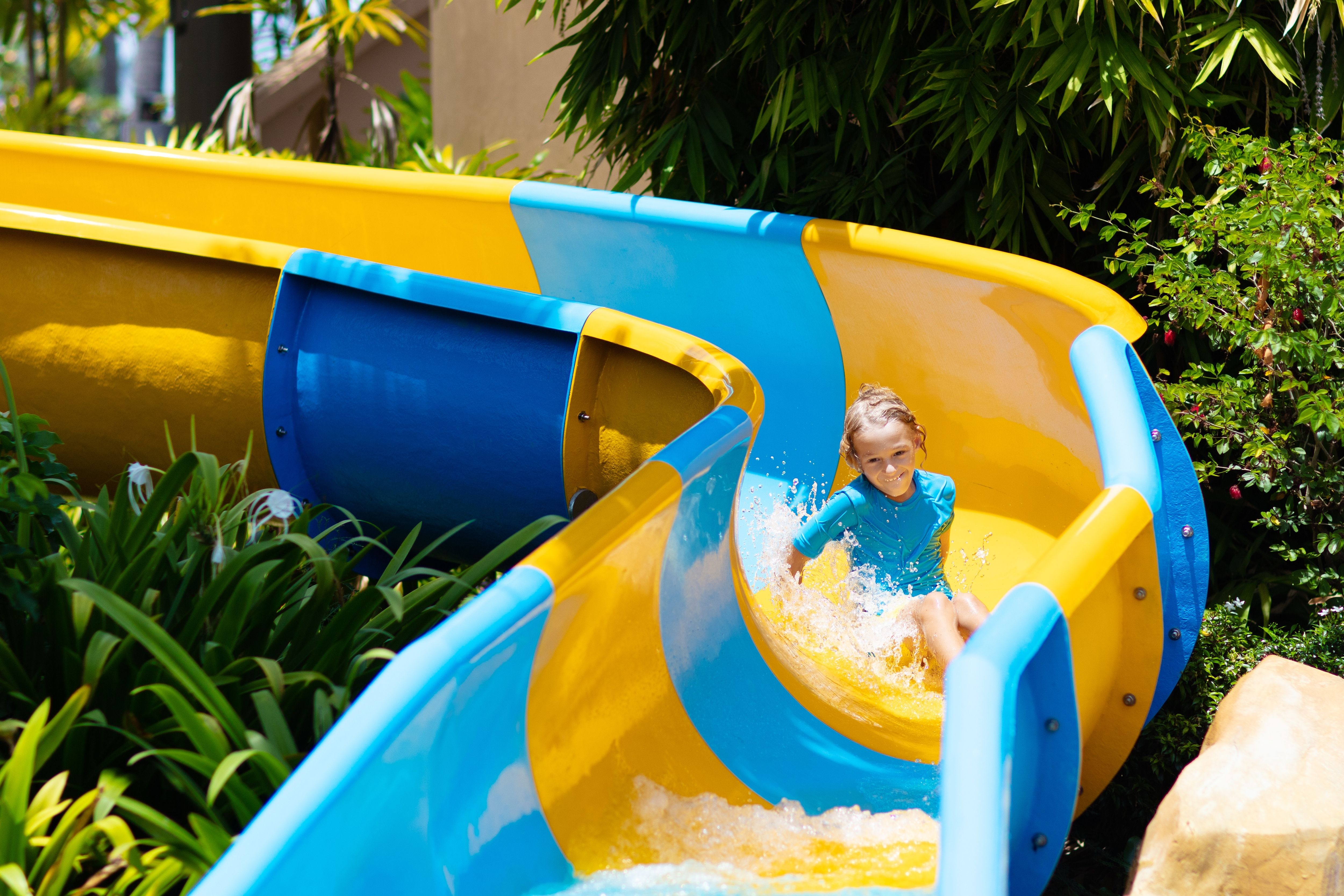 A child on a colourful waterslide at a waterpark