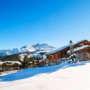 A view of Courchevel village showing chalets covered in snow in the Alps mountains, France