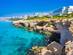A view of Ayia Napa Cape Cavo Greco blue lagoon resort with rocky seashore and clear blue waters in Cyprus