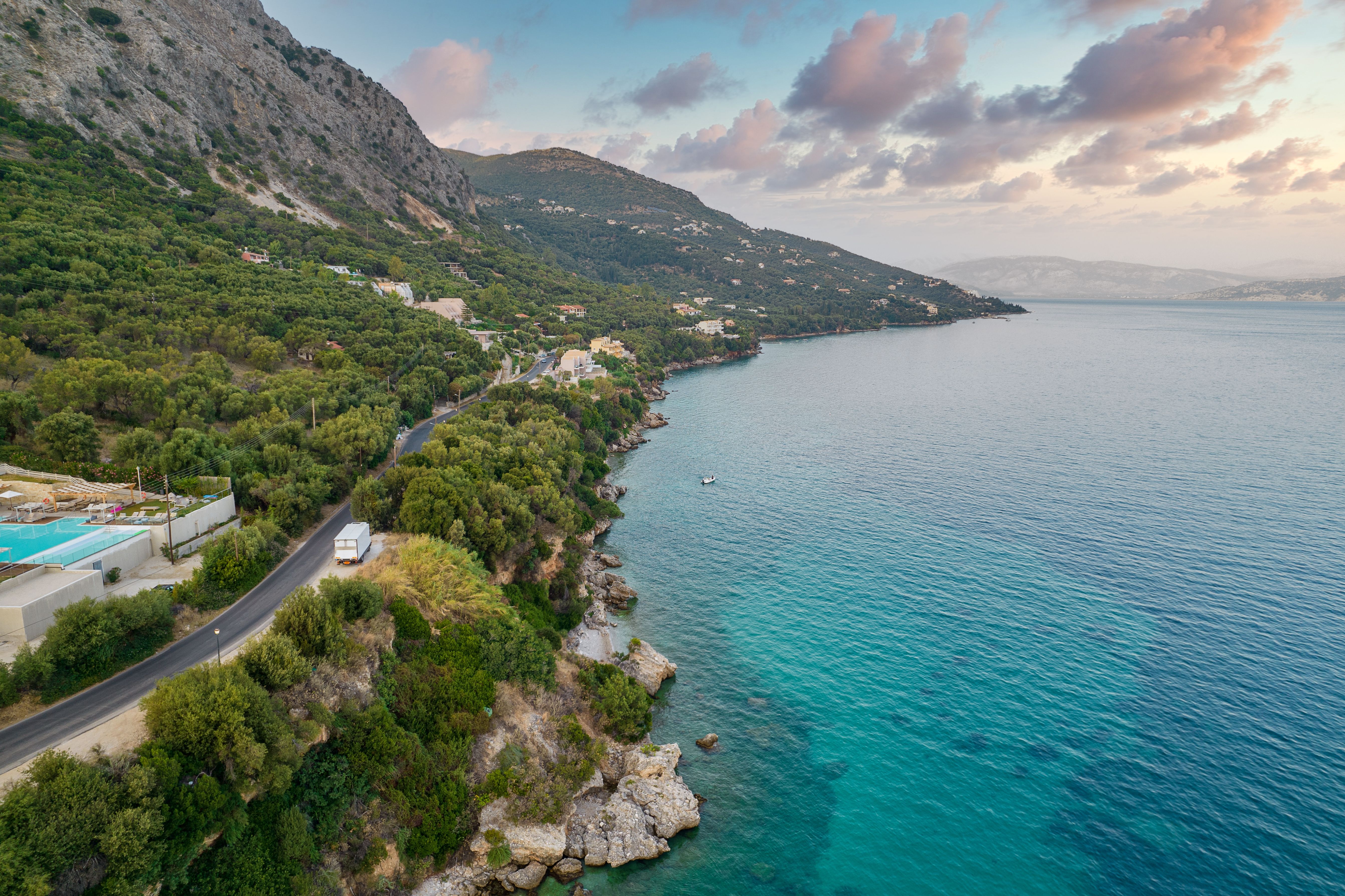 View of a road running along the rocky coastline of Corfu