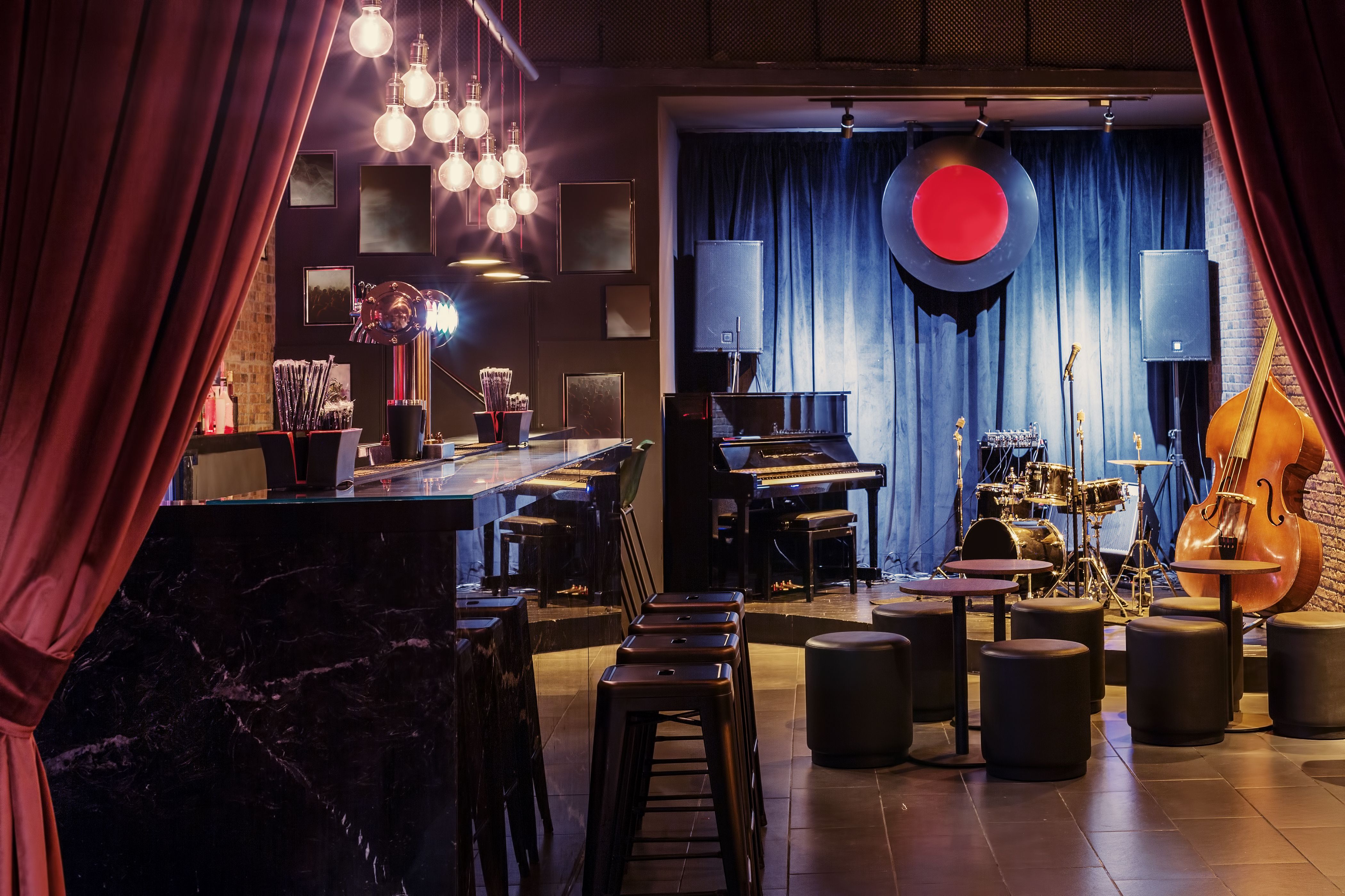 A modern jazz bar interior with a stage and a bar