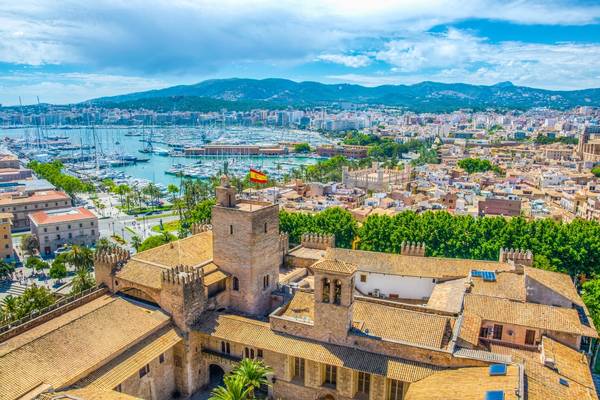 An aerial view of Palma de Majorca with Almudaina palace in the foreground and the skyline of Majorca and harbour in the background