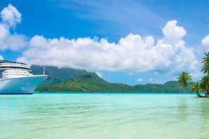 A panoramic view of a summer cruise ship anchored close to exotic tropical island of Bora Bora.