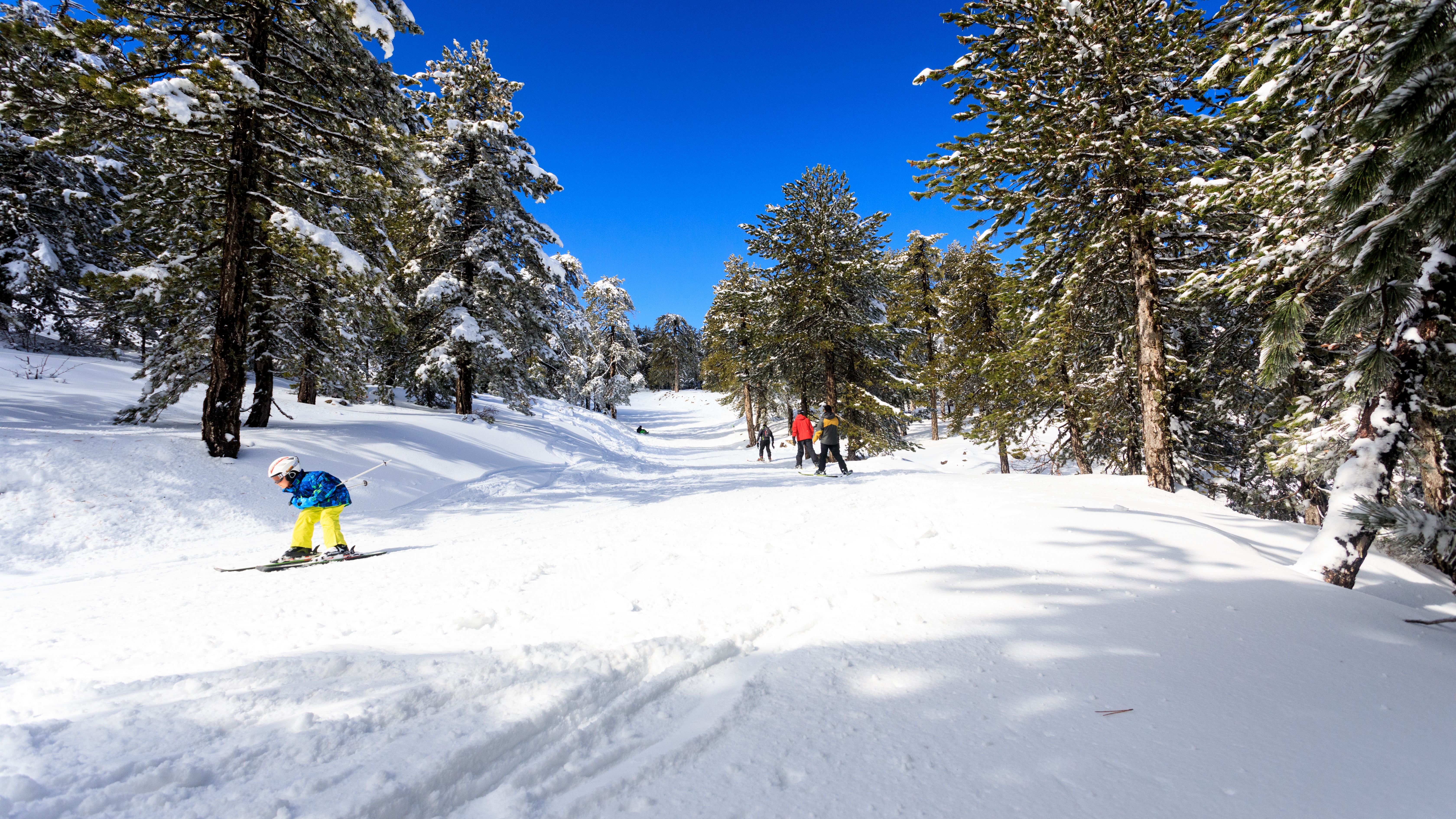 Skiers on snow covered slopes in the Troodos mountain range in Cyprus