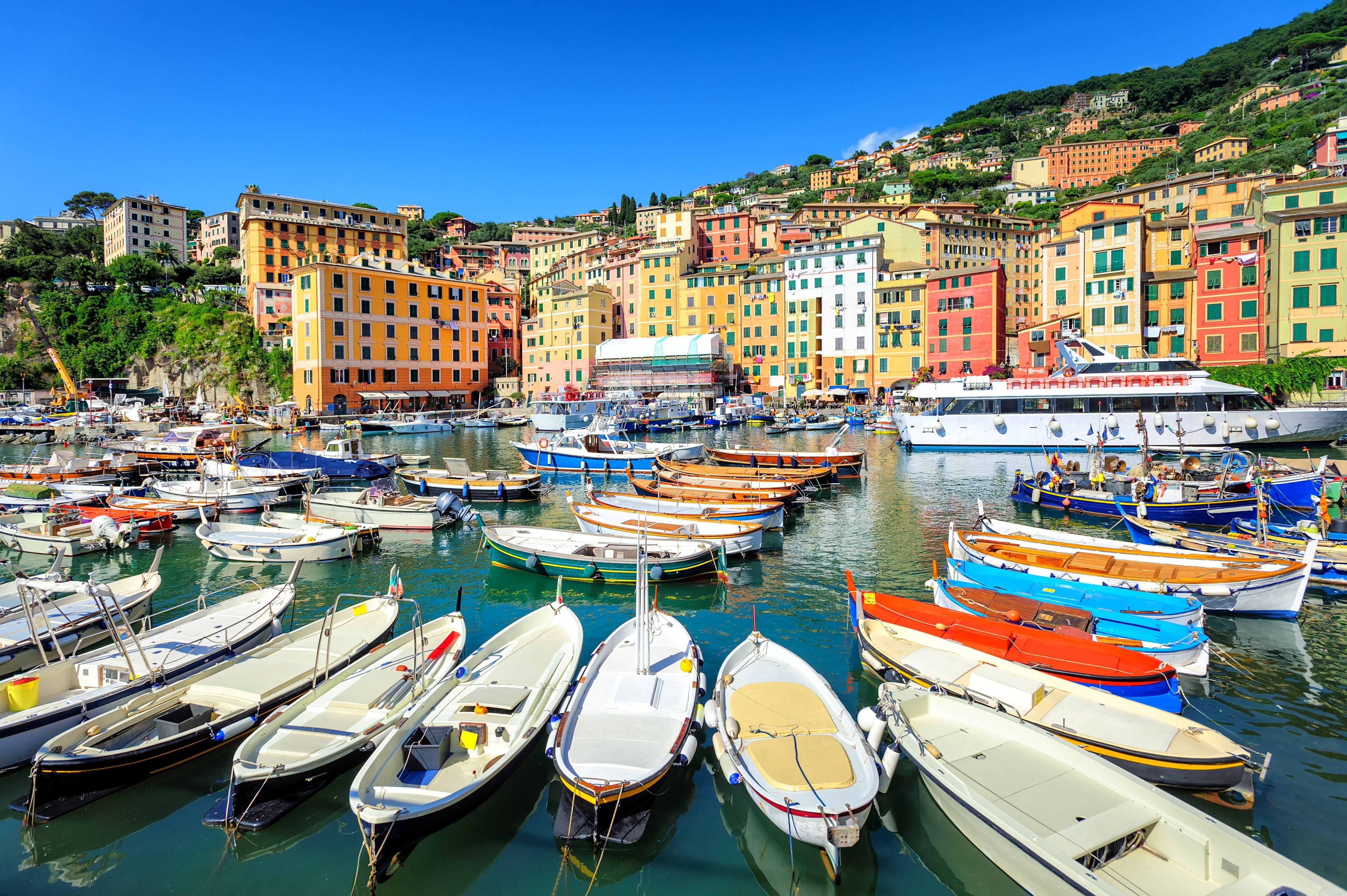 A view of colourful boats and waterfront buildings in Genoa, Italy