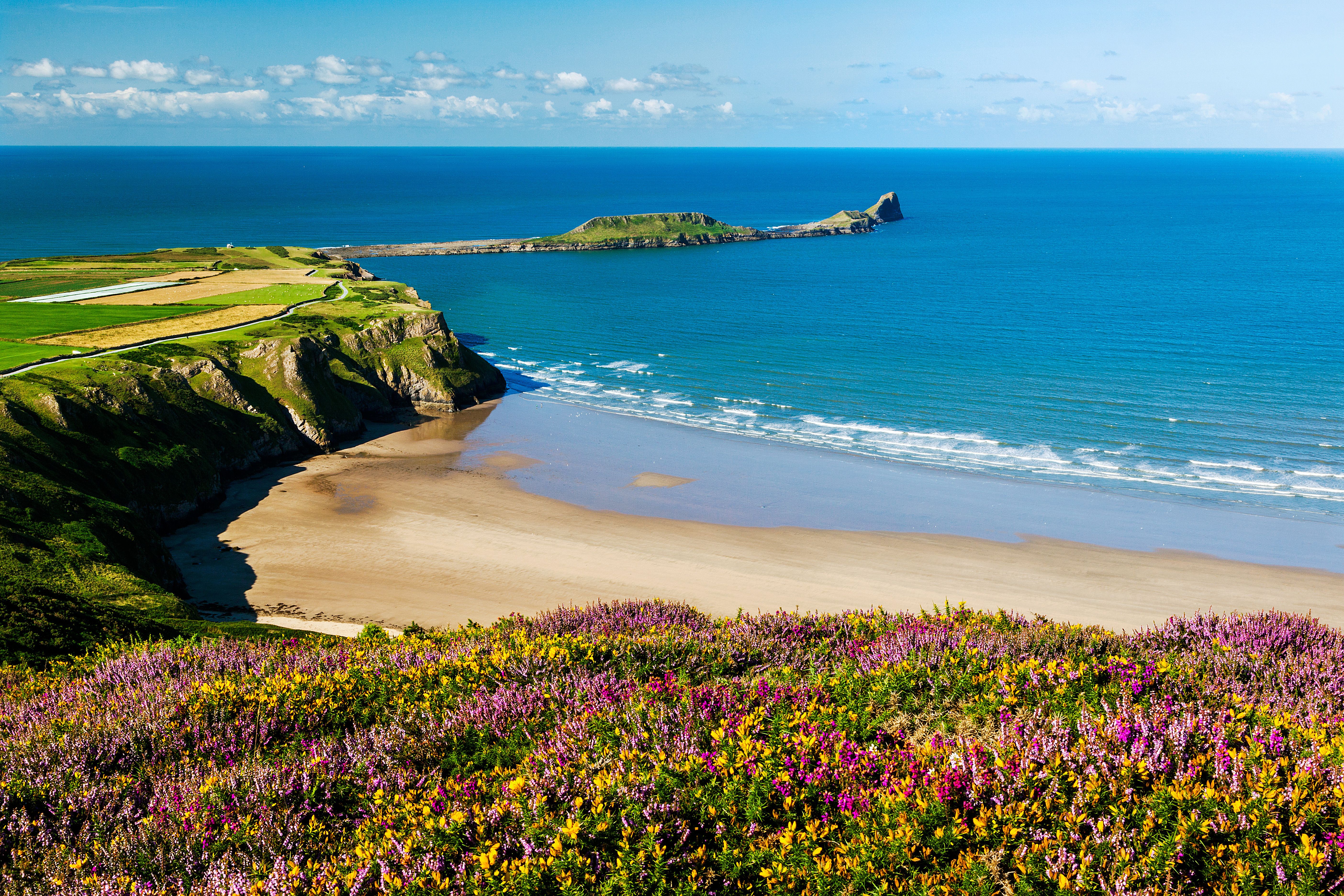 An aerial view of Rhossili Bay, Worms Head Gower, Peninsula, Wales
