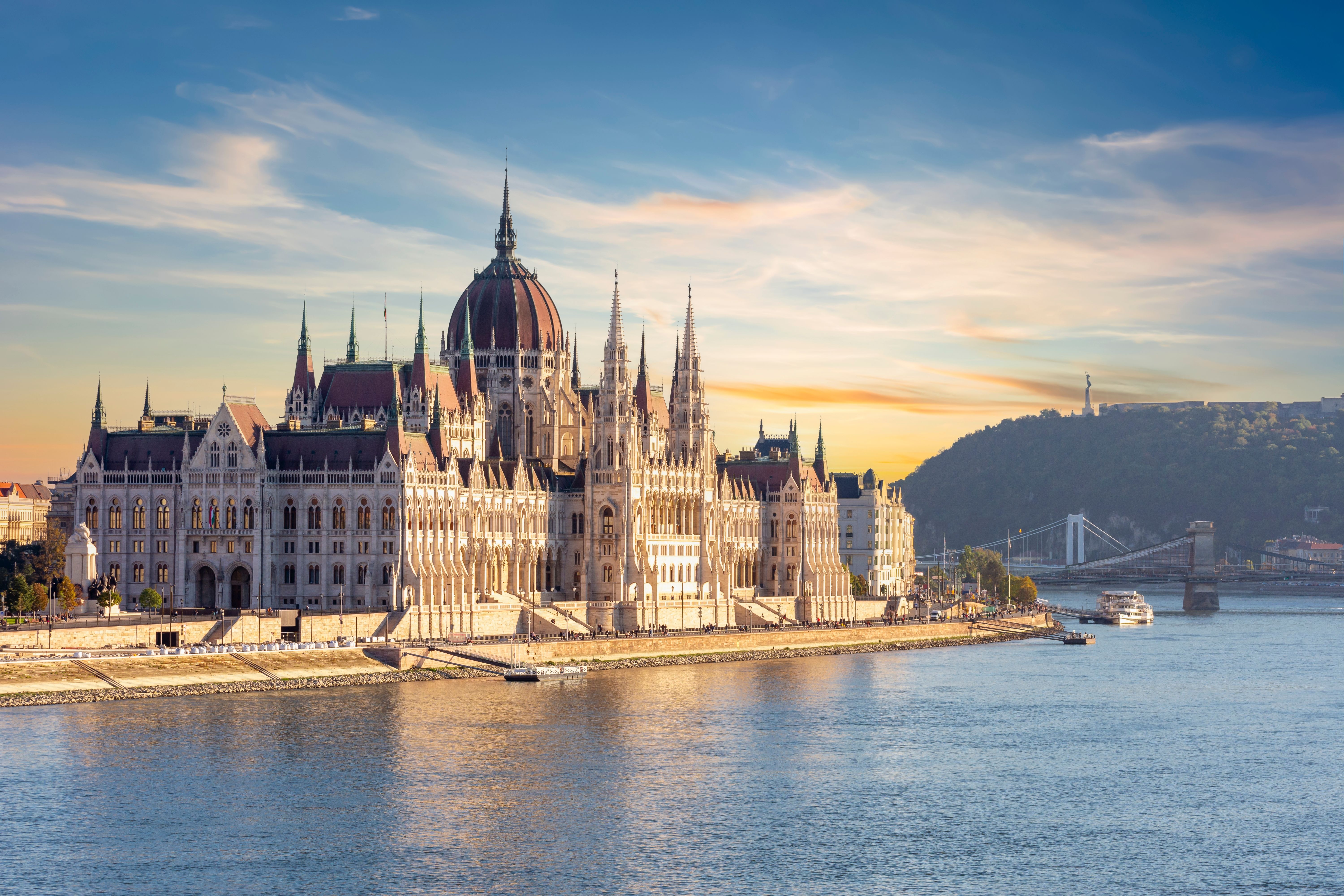 A view across the river of the Parliament building in Budapest at dusk
