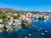 View of Cadaques town in the morning with moored fishing boats in the Costa Brava, Spain