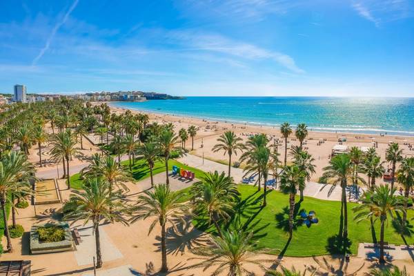A view showing palm trees and the beach of Salou city in Catalonia, Spain on a sunny day