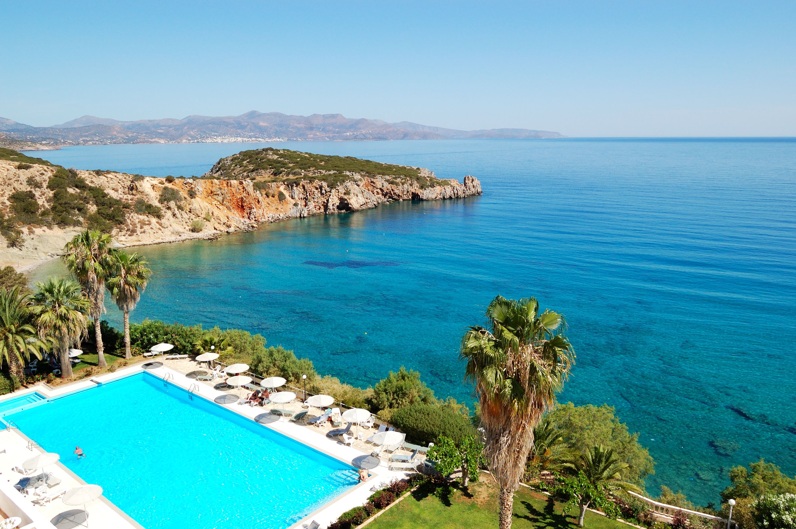 Aerial view of a seaside pool overlooking the clear waters of the Mediterranean