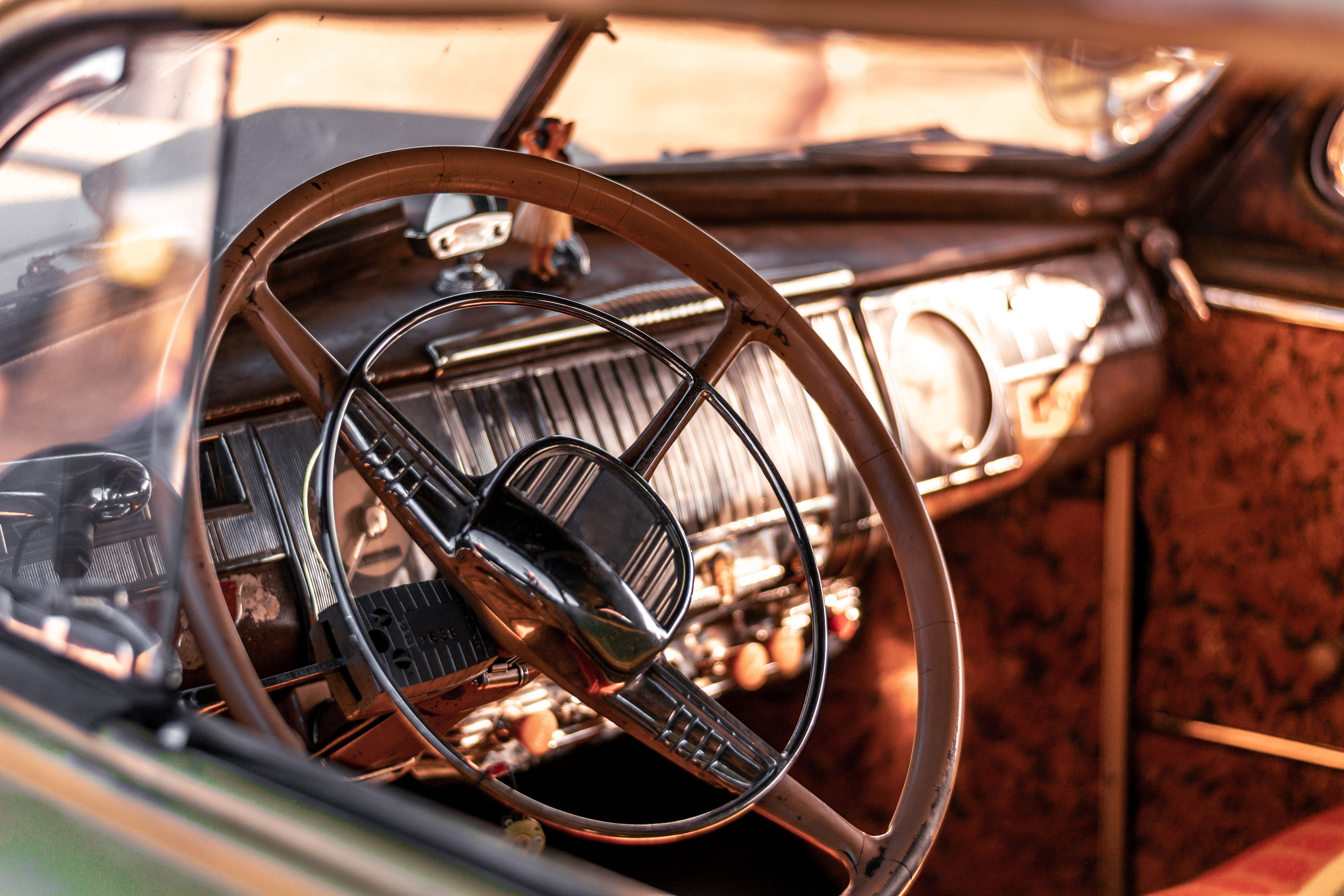 Close up image of the steering wheel and interior of a vintage car
