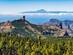 A landscape view of Roque Nublo in Gran Canaria, with pine-clad mountains