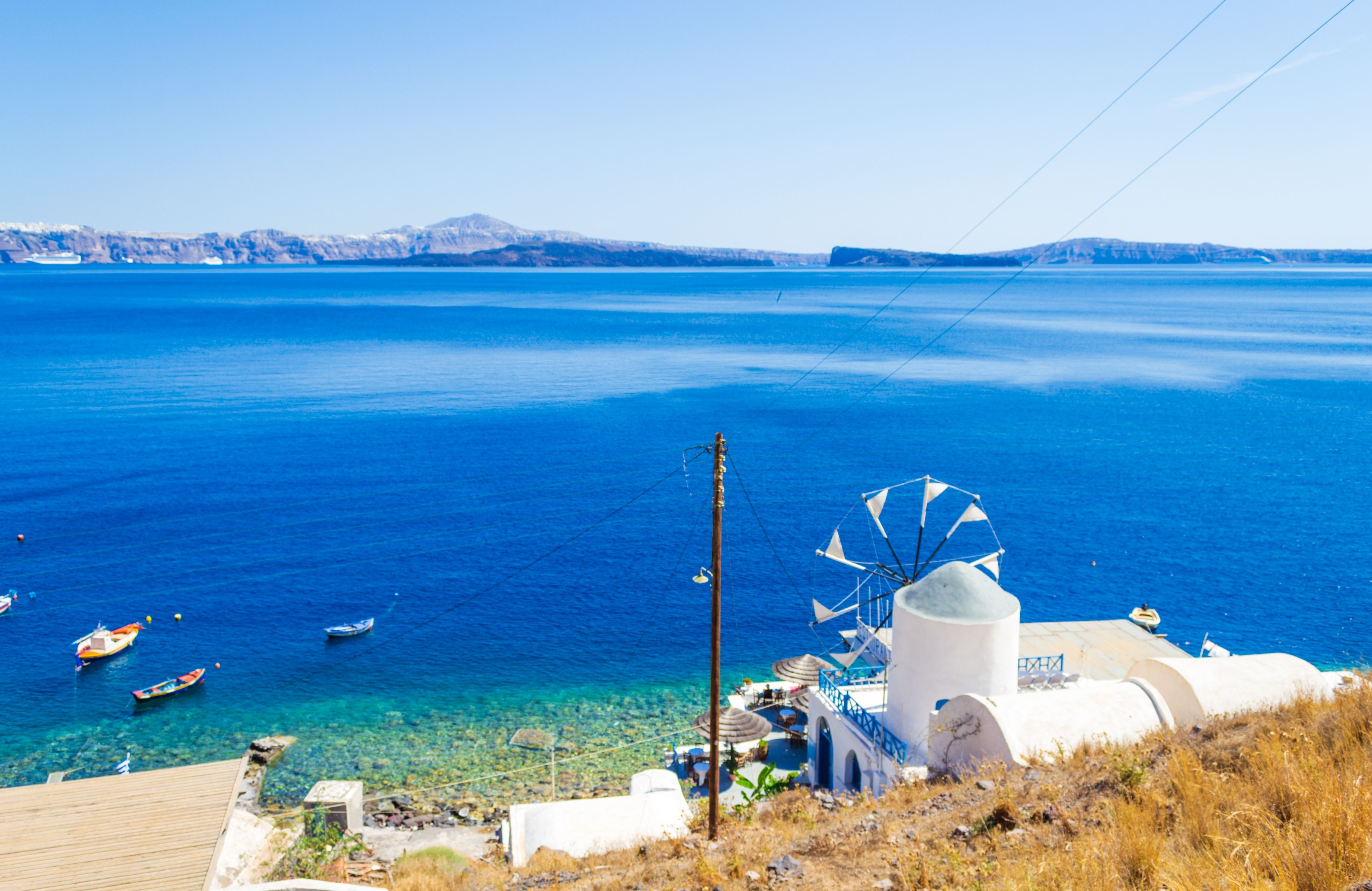 A view of a seafront windmill on the island of Thirasia in Greece